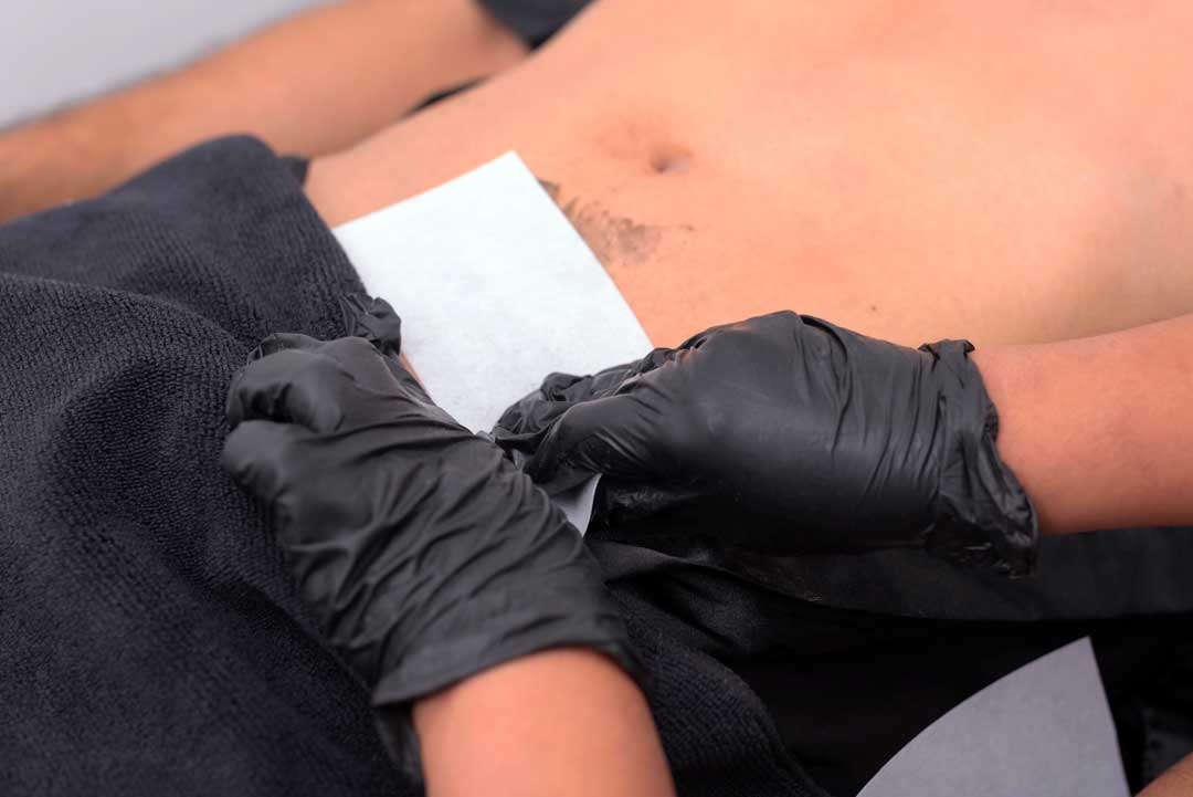 Beauty Therapist Performing Male Intimate Male Waxing Treatment